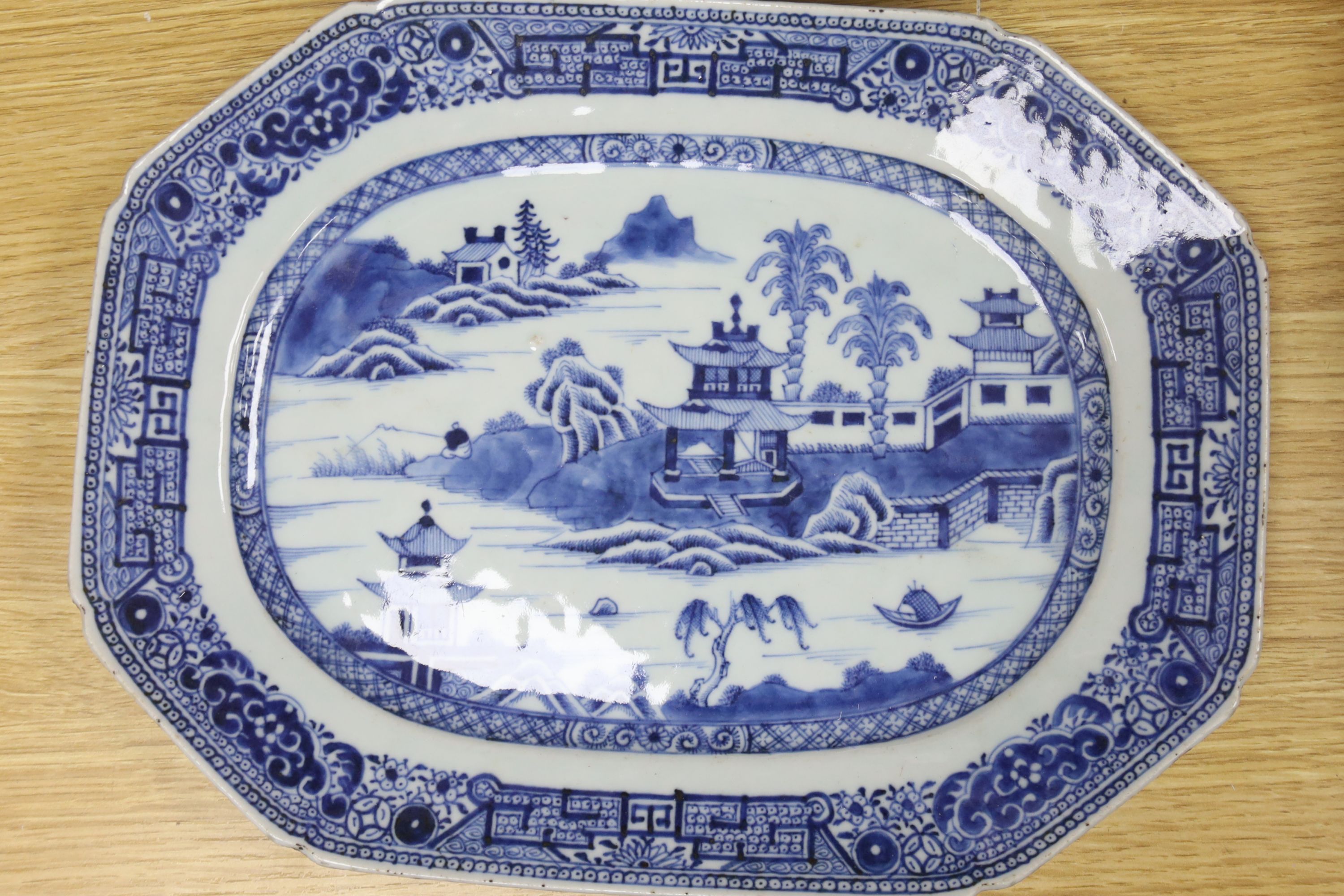 Three Chinese export blue and white meat dishes and a similar cover, Qianlong period, widest 33cm